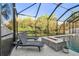 Relax by the screened-in pool with a fire pit and lovely views of the surrounding landscape at 8628 Eagle Brook Dr, Land O Lakes, FL 34638