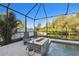 A screened pool area with a fire pit and waterfall feature, offering a serene outdoor escape at 8628 Eagle Brook Dr, Land O Lakes, FL 34638