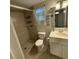 Bathroom featuring a shower stall, modern vanity with a sink, and decorative wall hangings at 9618 N 13Th St, Tampa, FL 33612