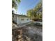 View of the side of the house with a picnic table in the yard at 9618 N 13Th St, Tampa, FL 33612