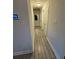 Neutral hallway with white doors and wood-look tile flooring at 9618 N 13Th St, Tampa, FL 33612