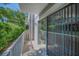 View of the balcony featuring a sliding glass door and lush green plants at 985 Wellington Ct, Dunedin, FL 34698
