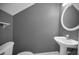 Cozy half-bath with a pedestal sink and gray walls at 985 Wellington Ct, Dunedin, FL 34698