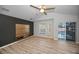 Bedroom with wood floors, ceiling fan, and sliding door access at 985 Wellington Ct, Dunedin, FL 34698