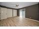 Neutral bedroom features a ceiling fan, sliding glass door, and multiple closets at 985 Wellington Ct, Dunedin, FL 34698