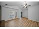 Bedroom featuring wood floors, a ceiling fan, and access to a balcony at 985 Wellington Ct, Dunedin, FL 34698