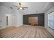 Bright bedroom with a modern accent wall, built-in shelving, and natural light at 985 Wellington Ct, Dunedin, FL 34698