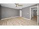 Bright bedroom with ceiling fan, light gray walls, and modern wood-look flooring at 985 Wellington Ct, Dunedin, FL 34698