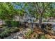 A private gated community entrance featuring lush landscaping and well-maintained sidewalks at 985 Wellington Ct, Dunedin, FL 34698