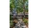 A private gated community entrance featuring lush landscaping and well-maintained sidewalks at 985 Wellington Ct, Dunedin, FL 34698