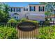 The Wellington community sign surrounded by a decorative black metal fence at 985 Wellington Ct, Dunedin, FL 34698