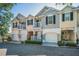 Townhomes each with individual garages and quaint balconies, offering a welcoming curb appeal at 985 Wellington Ct, Dunedin, FL 34698
