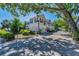 Well-maintained two-story home featuring a quaint driveway and landscaped yard at 985 Wellington Ct, Dunedin, FL 34698