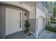 Close up of front entrance, featuring a solid door with glass accents and attached garage at 985 Wellington Ct, Dunedin, FL 34698