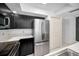 Modern kitchen featuring stainless steel appliances and sleek black cabinetry at 985 Wellington Ct, Dunedin, FL 34698