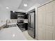 Well-lit kitchen with stainless steel appliances, quartz countertops, and modern cabinets at 985 Wellington Ct, Dunedin, FL 34698