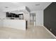 Bright, open-concept living space with tile flooring and easy kitchen access at 985 Wellington Ct, Dunedin, FL 34698