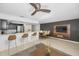 Open-concept living and kitchen area with breakfast bar seating and modern appliances at 985 Wellington Ct, Dunedin, FL 34698