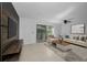 Bright living room with tile floors, contemporary furniture, and sliding glass doors at 985 Wellington Ct, Dunedin, FL 34698