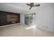 Spacious living room with tiled floor and sliding glass door leading to the patio at 985 Wellington Ct, Dunedin, FL 34698