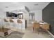 Open-concept space with modern kitchen and living areas, with tile floors and breakfast bar at 985 Wellington Ct, Dunedin, FL 34698