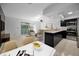 Open-concept living area and kitchen with modern appliances and access to a patio at 985 Wellington Ct, Dunedin, FL 34698