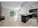 Spacious living room with sliding glass doors and a modern kitchen at 985 Wellington Ct, Dunedin, FL 34698