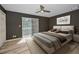 Contemporary main bedroom with wood floors, neutral colors, and a sliding glass door at 985 Wellington Ct, Dunedin, FL 34698