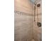 Detailed view of the stylish tile shower with modern fixtures at 985 Wellington Ct, Dunedin, FL 34698