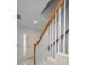 Staircase with wooden railing and white risers leading upstairs from the entryway at 985 Wellington Ct, Dunedin, FL 34698