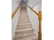 Staircase with wood-look steps and a white banister at 985 Wellington Ct, Dunedin, FL 34698
