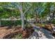 Beautiful community walkway with lush landscaping and mature trees at 985 Wellington Ct, Dunedin, FL 34698