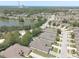 Aerial shot showcases homes near a serene lake, with lush greenery and a clear view of the water and neighborhood layout at 1023 Orca Ct, Holiday, FL 34691