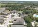 Community aerial view showcasing well-maintained homes, lush landscaping, pool, and surrounding trees at 1023 Orca Ct, Holiday, FL 34691