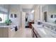 Bathroom featuring double sinks, a garden tub, and nautical decor at 1023 Orca Ct, Holiday, FL 34691