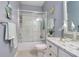 Bright bathroom with a glass enclosed shower, modern fixtures, and coastal-themed decor at 1023 Orca Ct, Holiday, FL 34691