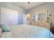 Well-lit bedroom featuring a dresser and a view into an en-suite bathroom at 1023 Orca Ct, Holiday, FL 34691