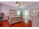 Bedroom with hardwood floors, ceiling fan, and ensuite bath, offering a tranquil retreat at 1023 Orca Ct, Holiday, FL 34691