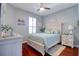 Cozy bedroom with wood flooring, a ceiling fan, and ample natural light at 1023 Orca Ct, Holiday, FL 34691