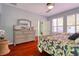 Bedroom featuring hardwood floors, a ceiling fan, and a light-colored dresser at 1023 Orca Ct, Holiday, FL 34691