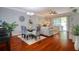 Dining room featuring hardwood floors and a glass dining table with decorative chairs at 1023 Orca Ct, Holiday, FL 34691