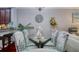 Dining room showcasing glass table and decorative chairs and an ornamental goose centerpiece at 1023 Orca Ct, Holiday, FL 34691
