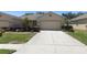 Beautiful home exterior with a manicured lawn, tasteful landscaping, and a spacious driveway at 1023 Orca Ct, Holiday, FL 34691