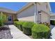 Close up of the front exterior with neatly trimmed green bushes and tropical plants at 1023 Orca Ct, Holiday, FL 34691