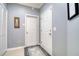 Neutral-toned hallway leading to other rooms with storage space, and neutral tile flooring at 1023 Orca Ct, Holiday, FL 34691
