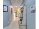 Inviting hallway with decorative bench, coat hooks, and tile flooring providing a welcoming entrance at 1023 Orca Ct, Holiday, FL 34691