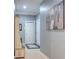 Hallway with artwork, accent furniture, and tile flooring, offering a warm and inviting welcome at 1023 Orca Ct, Holiday, FL 34691