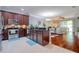 Open-concept kitchen with stainless appliances, dark wood cabinets, and granite countertops at 1023 Orca Ct, Holiday, FL 34691