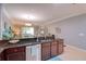 Open kitchen featuring granite counters, stainless steel dishwasher, and dark wood cabinets at 1023 Orca Ct, Holiday, FL 34691