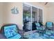 Relaxing screened lanai featuring comfortable wicker seating and a view of the backyard at 1023 Orca Ct, Holiday, FL 34691